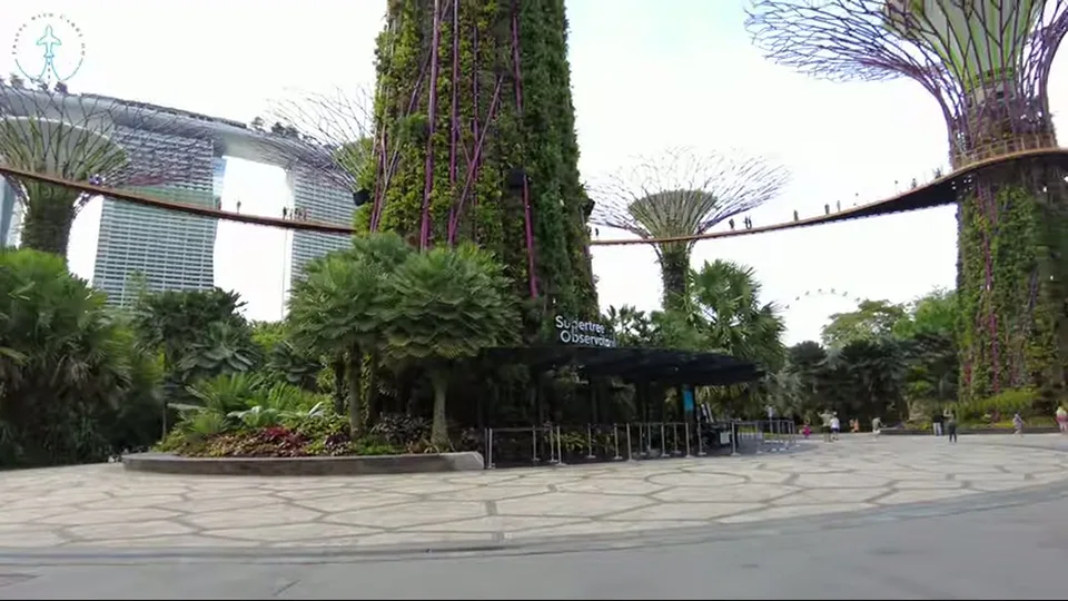 Scenic pond and sculpture with greenery and city skyline