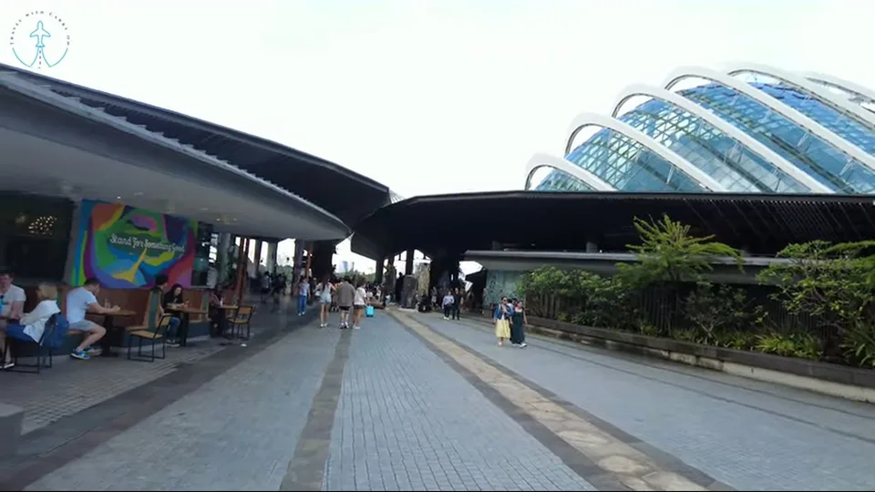Garden promenade leading toward Marina Bay Sands through lush landscaping